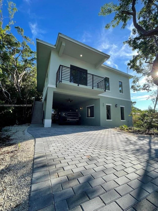 901 Estall St, Key Largo, FL 33037 - back of property featuring a balcony, stucco siding, and a carport