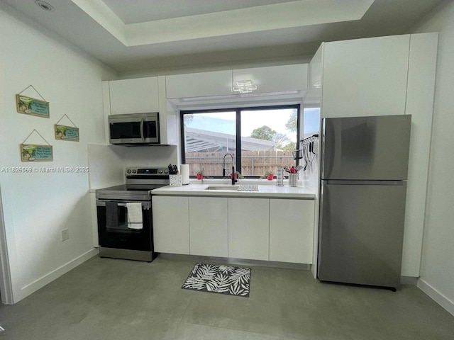 901 Estall St, Key Largo, FL 33037 - kitchen with appliances with stainless steel finishes, white cabinets, light countertops, and modern cabinets
