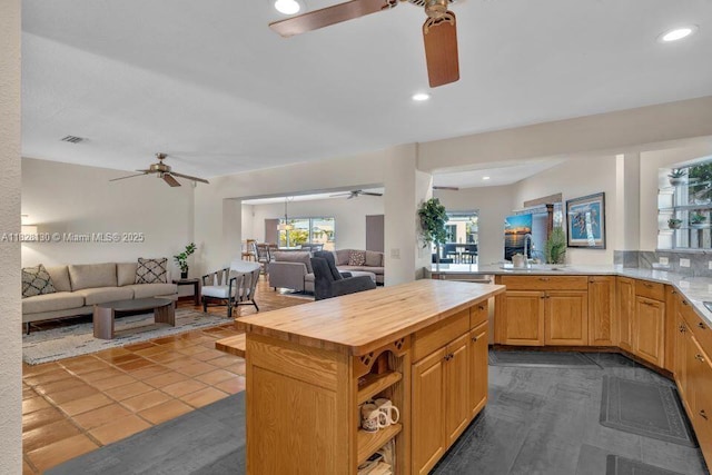 2108 NE 24th St, Wilton Manors, FL 33305 - kitchen featuring a ceiling fan, open floor plan, wood counters, recessed lighting, and dark tile patterned flooring