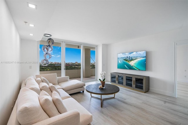3400 SW 27th Ave Unit 1605, Miami, FL 33133 - living area featuring light wood finished floors and floor to ceiling windows