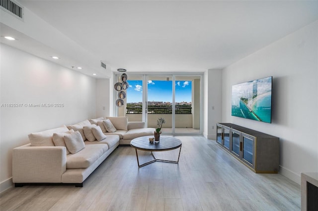 3400 SW 27th Ave Unit 1605, Miami, FL 33133 - living area with light wood finished floors, floor to ceiling windows, and recessed lighting