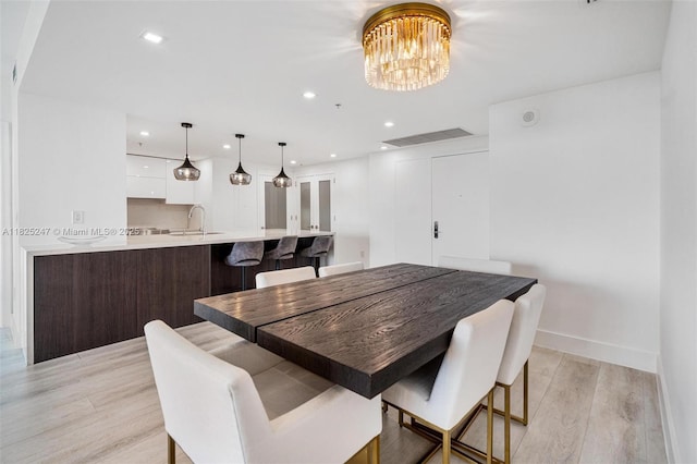 3400 SW 27th Ave Unit 1605, Miami, FL 33133 - dining area featuring light wood-style floors, a chandelier, and recessed lighting