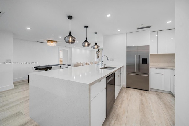 3400 SW 27th Ave Unit 1605, Miami, FL 33133 - kitchen featuring appliances with stainless steel finishes, modern cabinets, white cabinets, light wood finished floors, and light countertops