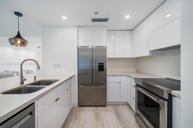 3400 SW 27th Ave Unit 1605, Miami, FL 33133 - kitchen featuring stainless steel appliances, modern cabinets, white cabinetry, pendant lighting, and recessed lighting