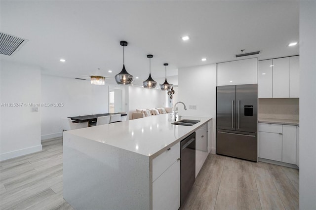 3400 SW 27th Ave Unit 1605, Miami, FL 33133 - kitchen featuring appliances with stainless steel finishes, modern cabinets, white cabinetry, light wood-style floors, and recessed lighting
