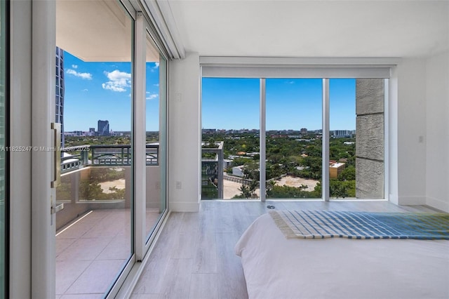 3400 SW 27th Ave Unit 1605, Miami, FL 33133 - bedroom with a view of city and wood finished floors