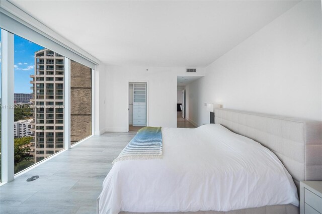 3400 SW 27th Ave Unit 1605, Miami, FL 33133 - bedroom with access to exterior, wood finished floors, and a view of city