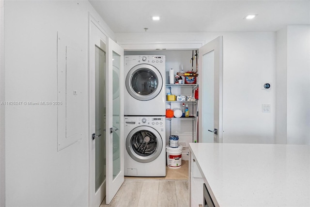 3400 SW 27th Ave Unit 1605, Miami, FL 33133 - laundry room featuring stacked washer / drying machine and light wood-style floors