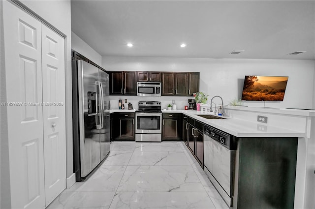 3574 W 88th Ter, Hialeah, FL 33018 - kitchen featuring stainless steel appliances, light marble finish floors, light countertops, recessed lighting, and dark brown cabinets