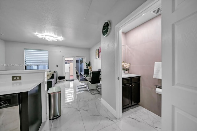 3574 W 88th Ter, Hialeah, FL 33018 - kitchen with light marble finish floors, dark cabinets, and light countertops