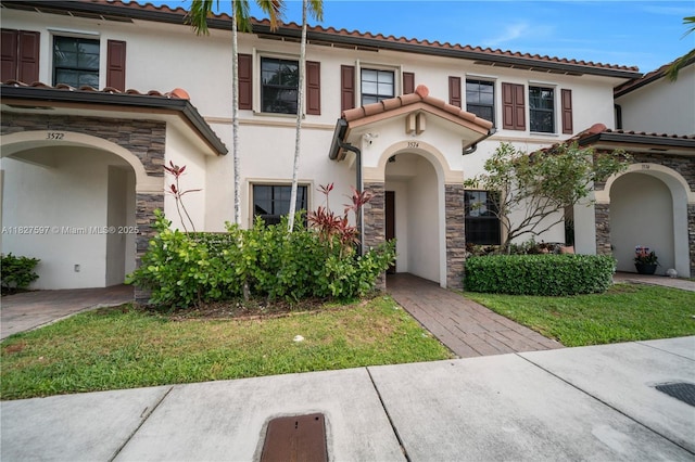 3574 W 88th Ter, Hialeah, FL 33018 - mediterranean / spanish-style home with stone siding, stucco siding, and a tile roof