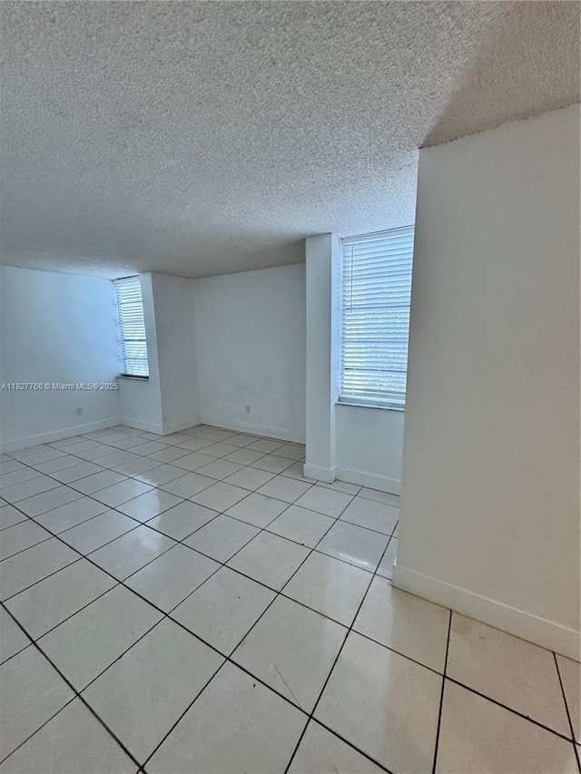 12105 NE 6th Ave Unit 304, North Miami, FL 33161 - empty room featuring a textured ceiling and light tile patterned flooring