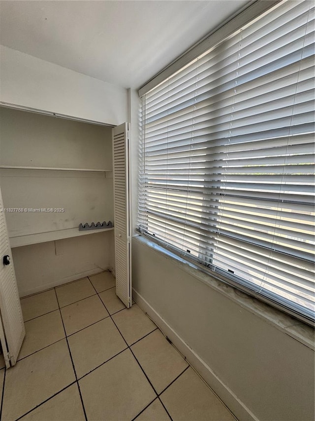 12105 NE 6th Ave Unit 304, North Miami, FL 33161 - interior space with tile patterned floors and baseboards