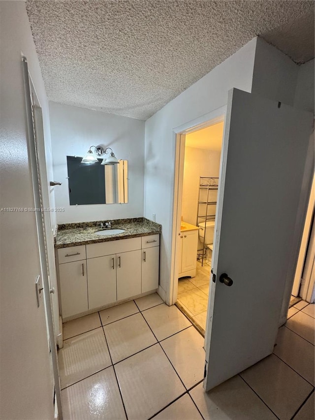 12105 NE 6th Ave Unit 304, North Miami, FL 33161 - bathroom with a textured ceiling, vanity, and tile patterned flooring