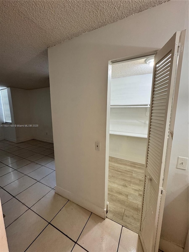 12105 NE 6th Ave Unit 304, North Miami, FL 33161 - hallway with a textured ceiling and light tile patterned flooring