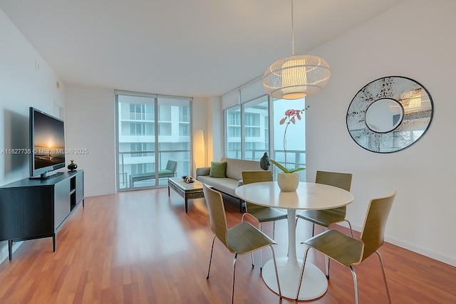 333 NE 24th St Unit 1401, Miami, FL 33137 - dining room with light wood-style flooring and baseboards