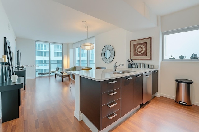 333 NE 24th St Unit 1401, Miami, FL 33137 - kitchen with modern cabinets, light wood finished floors, dark brown cabinets, light countertops, and stainless steel dishwasher