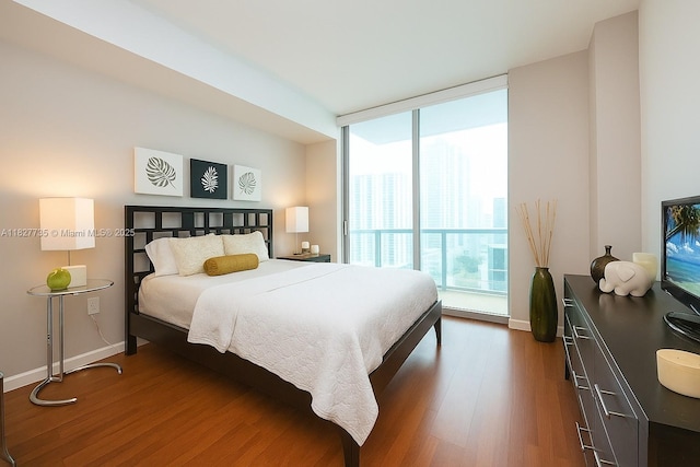 333 NE 24th St Unit 1401, Miami, FL 33137 - bedroom featuring dark wood-type flooring and baseboards