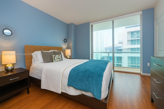 333 NE 24th St Unit 1401, Miami, FL 33137 - bedroom featuring wood finished floors and expansive windows