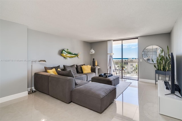1500 S Ocean Dr Unit 7K, Hollywood, FL 33019 - living area with expansive windows, a textured ceiling, and light tile patterned flooring