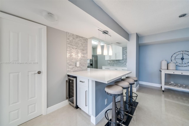 1500 S Ocean Dr Unit 7K, Hollywood, FL 33019 - kitchen with wine cooler, stainless steel fridge with ice dispenser, a kitchen breakfast bar, and white cabinets