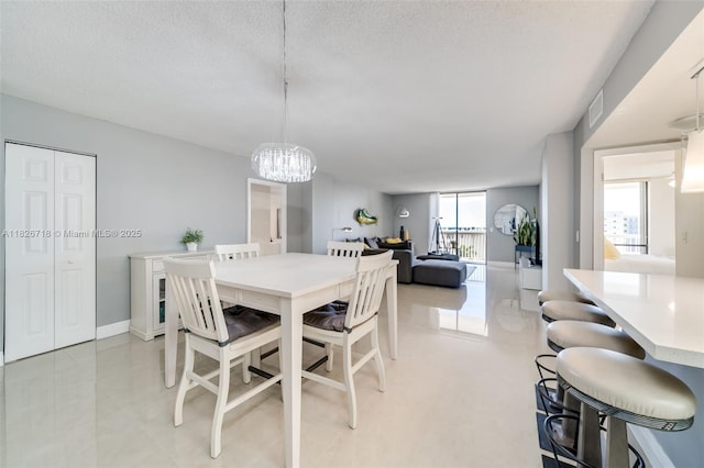 1500 S Ocean Dr Unit 7K, Hollywood, FL 33019 - dining space featuring a chandelier and a textured ceiling