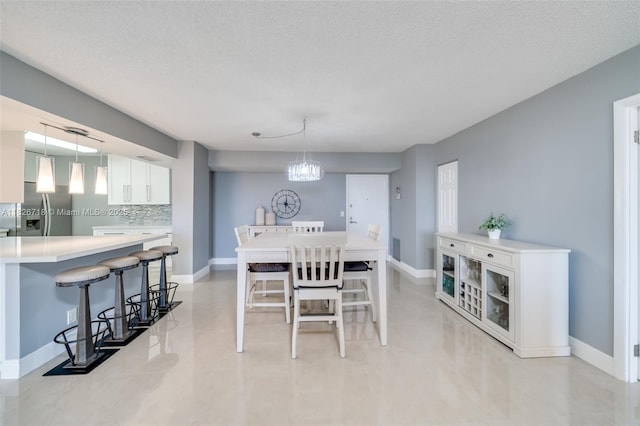 1500 S Ocean Dr Unit 7K, Hollywood, FL 33019 - dining area featuring a textured ceiling and a chandelier