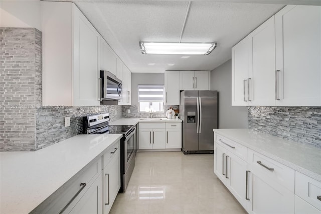 1500 S Ocean Dr Unit 7K, Hollywood, FL 33019 - kitchen featuring appliances with stainless steel finishes, tasteful backsplash, white cabinets, light countertops, and a textured ceiling