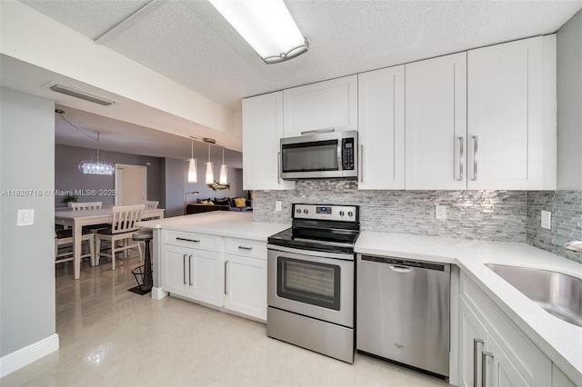 1500 S Ocean Dr Unit 7K, Hollywood, FL 33019 - kitchen featuring appliances with stainless steel finishes, tasteful backsplash, white cabinets, light countertops, and a textured ceiling