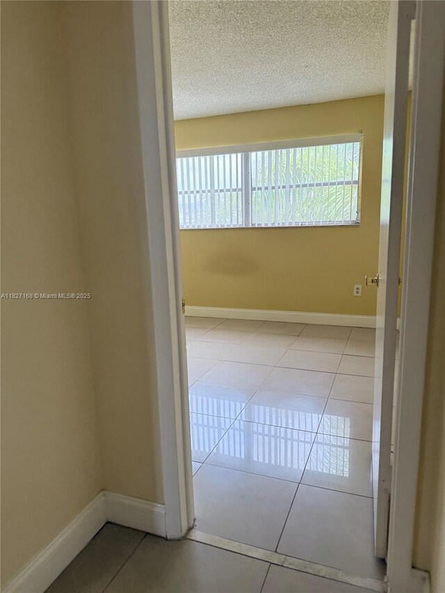 9365 Fontainebleau, Miami, FL 33172 - corridor with tile patterned flooring and a textured ceiling