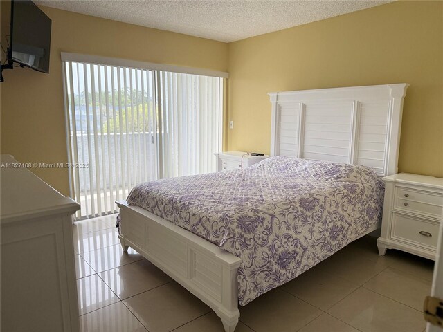 9365 Fontainebleau, Miami, FL 33172 - bedroom featuring access to outside, multiple windows, light tile patterned floors, and a textured ceiling