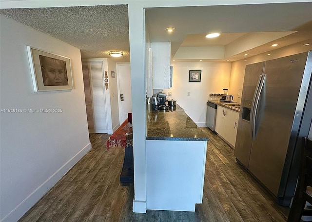13499 Biscayne Blvd Unit 1013, North Miami, FL 33181 - kitchen featuring stainless steel appliances, dark countertops, white cabinets, dark wood-style flooring, and recessed lighting