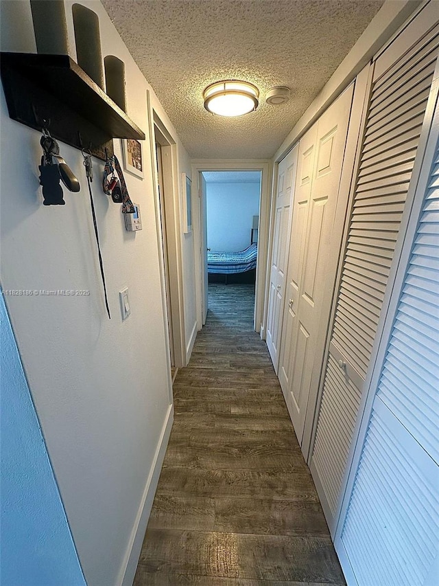 13499 Biscayne Blvd Unit 1013, North Miami, FL 33181 - hall featuring dark wood-type flooring and a textured ceiling