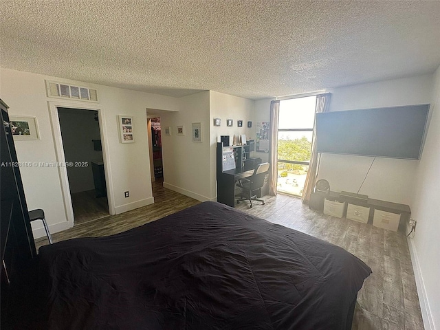 13499 Biscayne Blvd Unit 1013, North Miami, FL 33181 - bedroom with wood finished floors, a textured ceiling, and a spacious closet