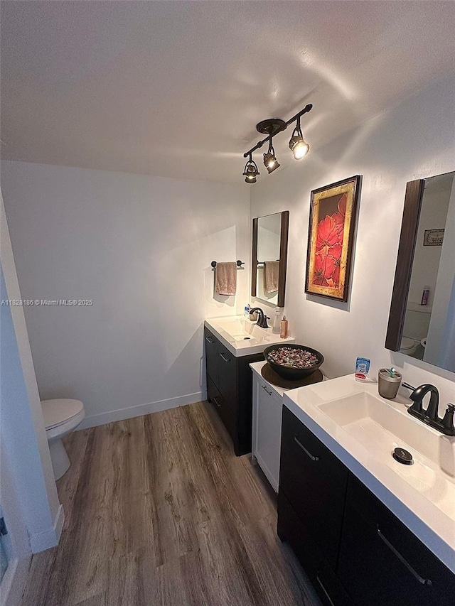 13499 Biscayne Blvd Unit 1013, North Miami, FL 33181 - bathroom featuring wood finished floors, two vanities, and rail lighting