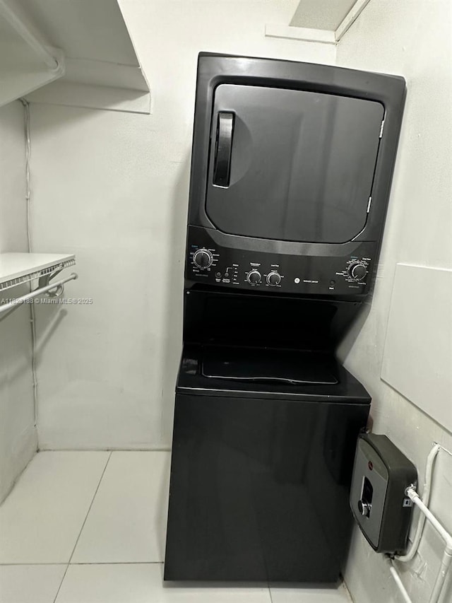 126 Mendoza Ave Unit 1, Coral Gables, FL 33134 - laundry area featuring estacked washer and dryer and tile patterned flooring