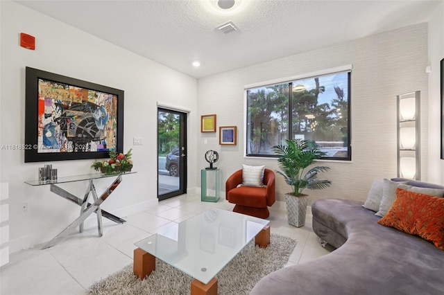 8001 NW 41st St Unit F-112, Doral, FL 33166 - tiled living area featuring baseboards and a textured ceiling