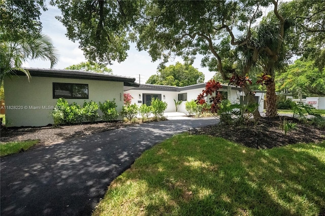 5850 Rose Ter, Plantation, FL 33317 - view of front of house featuring stucco siding and asphalt driveway
