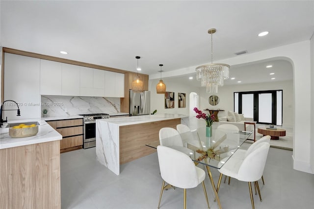 5850 Rose Ter, Plantation, FL 33317 - dining room featuring arched walkways, recessed lighting, and a chandelier