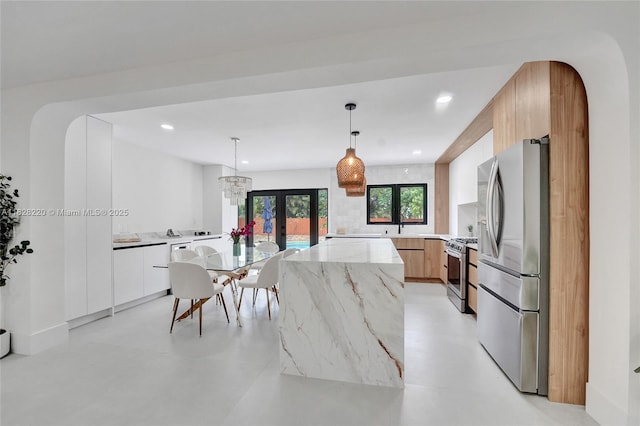 5850 Rose Ter, Plantation, FL 33317 - kitchen with stainless steel appliances, modern cabinets, light stone counters, decorative light fixtures, and recessed lighting