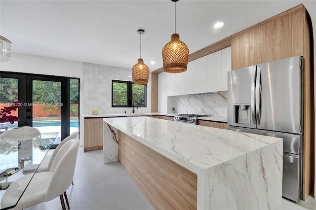 5850 Rose Ter, Plantation, FL 33317 - kitchen featuring stainless steel appliances, modern cabinets, backsplash, a kitchen island, and white cabinetry