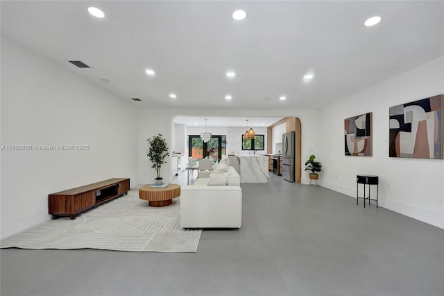 5850 Rose Ter, Plantation, FL 33317 - living room with arched walkways, recessed lighting, and concrete flooring