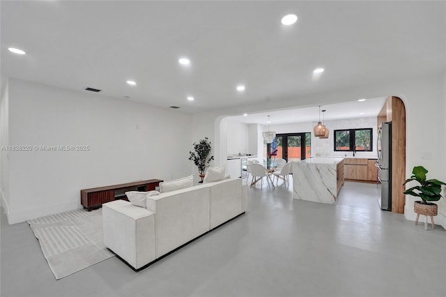 5850 Rose Ter, Plantation, FL 33317 - living room featuring arched walkways, recessed lighting, and finished concrete floors
