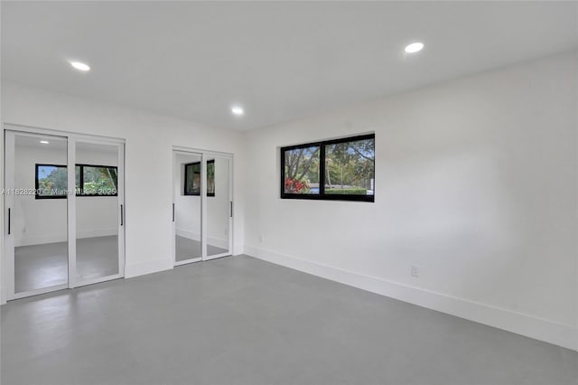 5850 Rose Ter, Plantation, FL 33317 - unfurnished bedroom featuring multiple closets, recessed lighting, and concrete floors