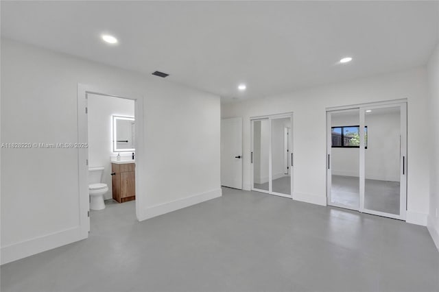 5850 Rose Ter, Plantation, FL 33317 - unfurnished bedroom with two closets, concrete flooring, recessed lighting, and ensuite bathroom