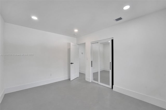5850 Rose Ter, Plantation, FL 33317 - unfurnished bedroom featuring finished concrete floors, recessed lighting, and a closet