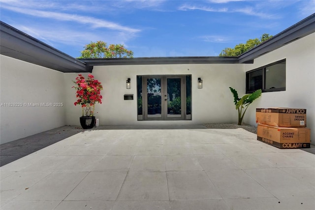 5850 Rose Ter, Plantation, FL 33317 - doorway to property featuring stucco siding, french doors, and a patio