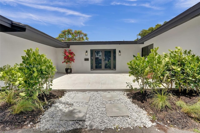 5850 Rose Ter, Plantation, FL 33317 - entrance to property with stucco siding, french doors, and a patio area