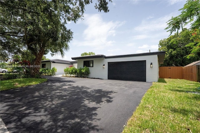 5850 Rose Ter, Plantation, FL 33317 - view of front of home featuring stucco siding, asphalt driveway, and an attached garage
