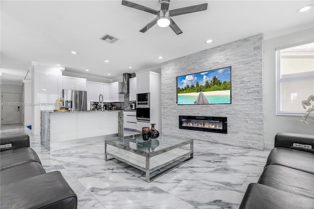 16488 SW 30th St, Miramar, FL 33027 - living area featuring recessed lighting, a ceiling fan, crown molding, a fireplace, and light marble finish flooring